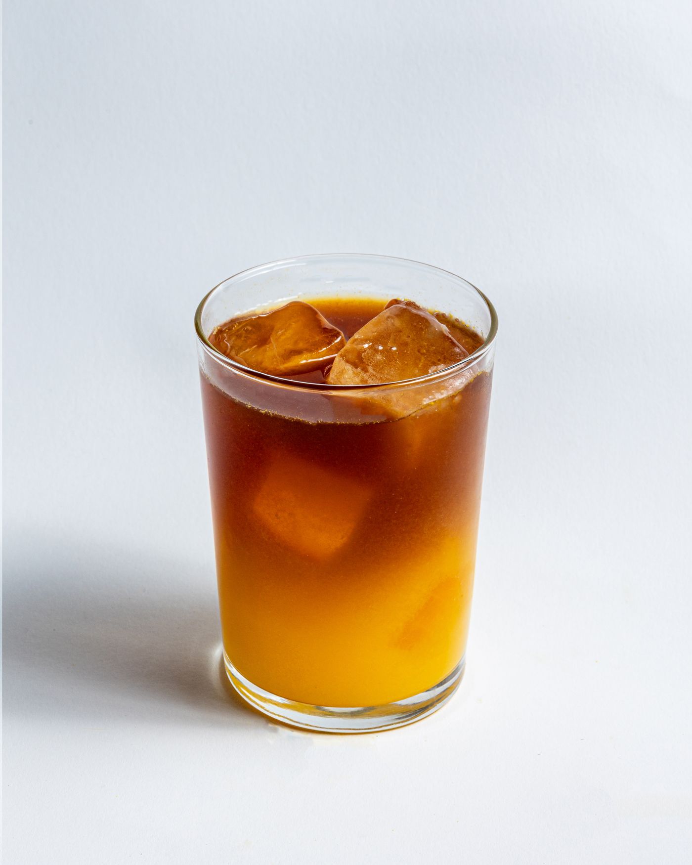 Iced coffee drink with orange in a glass with ice